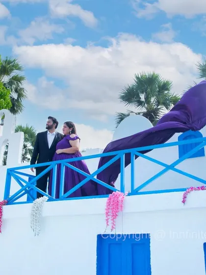 We bring the Greek isles to you with our authentic Santorini-inspired set. The iconic blue and white architecture, paired with a dramatic long-trail gown, makes for a stunning destination-style pre-wedding photo.