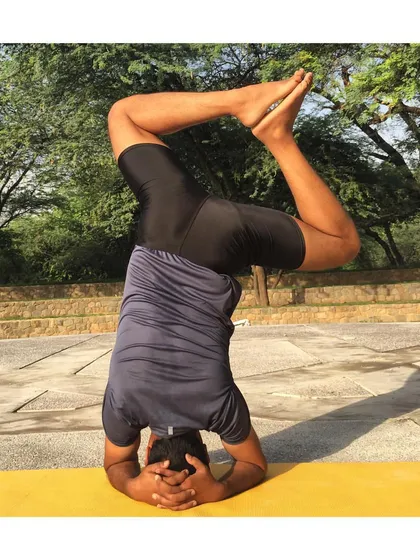 This is a variation of Sirsasana (Headstand) with bent knees. Playing with different leg positions in headstand challenges your core stability and helps you build greater control while inverted.
