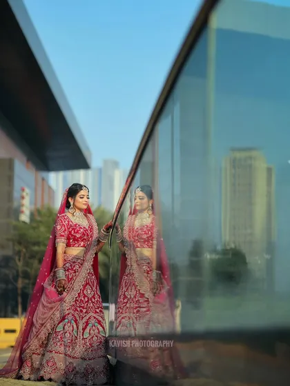 An artistic bridal portrait using the reflection in a glass wall to create a unique and modern composition.