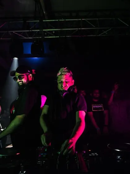 A dramatic, pink-lit shot of me and Ankytrixx at the decks, ready for another massive B2B set.