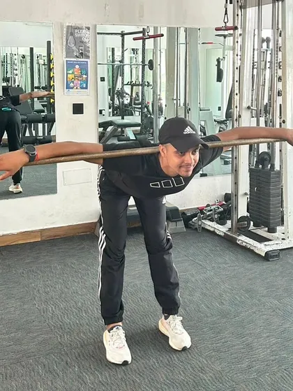 Demonstrating a good morning exercise with a stick to warm up the lower back and hamstrings. Proper form is everything.