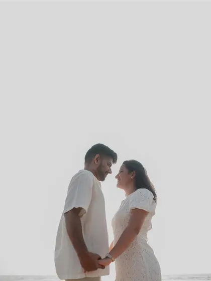 A minimalist, high-key silhouette against the bright sky. This artistic shot focuses on their connection and the feeling of being lost in their own world.
