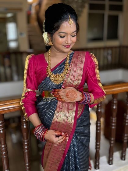 Another beautiful shot of Siri at her Seemantham. The puff-sleeve blouse and temple jewellery add a traditional touch to her glowing new-mom look.