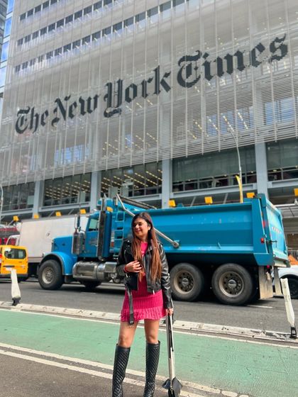 In front of The New York Times building, a truly iconic spot. My travel content often includes famous landmarks to create a strong sense of place.