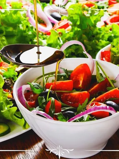 Healthy options are a core part of our offering. We create vibrant, fresh salads using seasonal ingredients, like this mix of greens, cherry tomatoes, and red onion, lightly dressed with olive oil.