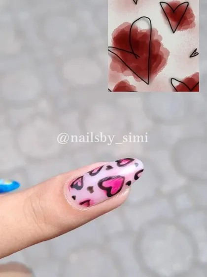 This nail features a trendy, abstract heart design with a watercolor effect, inspired by a Pinterest artwork.