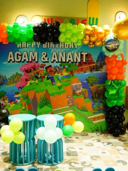 Building a world of fun with a Minecraft-themed birthday party. This setup features a custom backdrop and character props, perfect for any young gamer's special day.