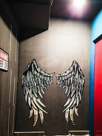 Another view of the finished angel wings at Westeros, HSR. This kind of interactive wall art is a smart marketing move that gets customers talking about your business.