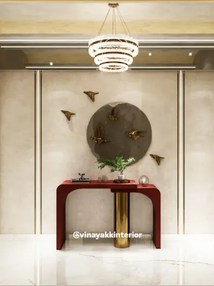 This entryway makes a bold statement with a striking red console table and artistic bird decor. The arched doorway and modern chandelier add architectural interest and a touch of sophistication.