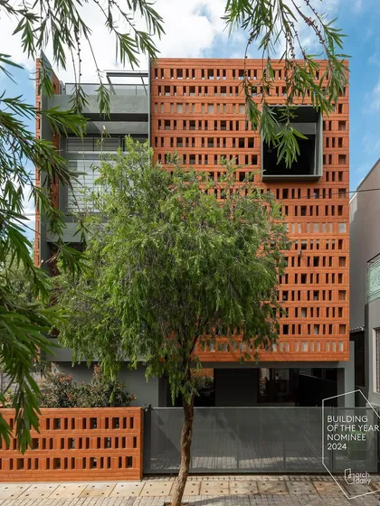 For the 'Big-Little House', we used a perforated brick screen to create a visually striking facade on a compact urban plot. This design provides privacy and ventilation while casting intricate light patterns, proving that even small footprints can have a grand architectural presence.