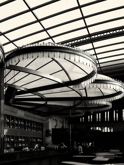 A close-up of the custom canopy lights over the bar. The fringe detail and radial structure are key design elements that contribute to the Calcutta-inspired theme.