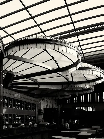 A close-up of the custom canopy lights over the bar. The fringe detail and radial structure are key design elements that contribute to the Calcutta-inspired theme.