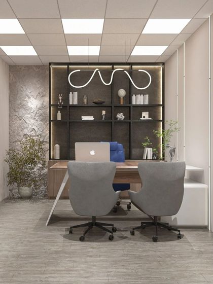 A private office cabin with a focus on minimalism and functionality. The design includes a sleek desk, comfortable seating, and a unique overhead light fixture.