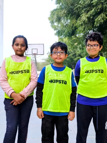 Three players standing proud in their practice vests. We aim to instill focus and discipline in a way that feels encouraging, not pressuring.