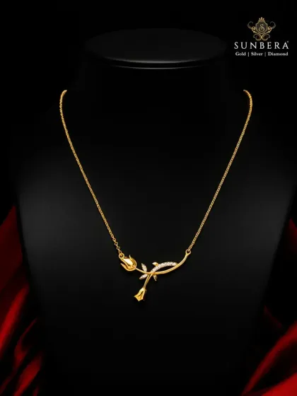 A delicate rose crafted in 22K gold, this necklace is a symbol of timeless love. The design features a blooming rosebud on a gently curved stem, accented with small diamonds for a touch of sparkle.