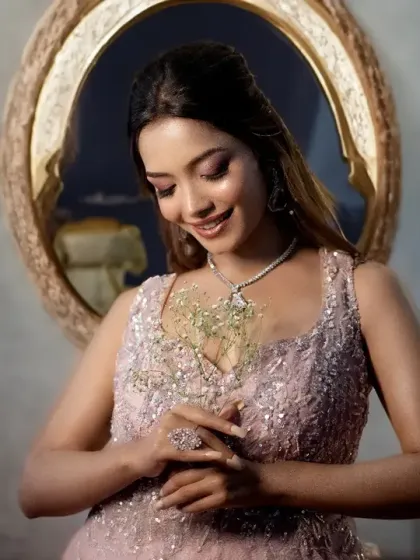 A graceful bridal portrait, capturing the bride admiring her engagement ring. The soft lighting and elegant pose create a timeless feel.