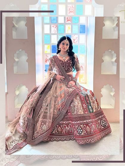 Seated by a window, the bride looks radiant in this heavily embroidered lehenga, a perfect blend of tradition and style.