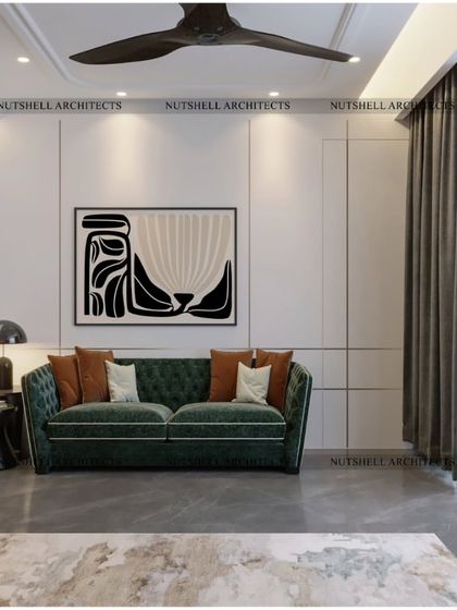 A minimalist take on the home office, this space features a striking emerald green sofa set against clean white walls. A bold piece of abstract art adds personality, creating a space that is both stylish and conducive to creative thinking.