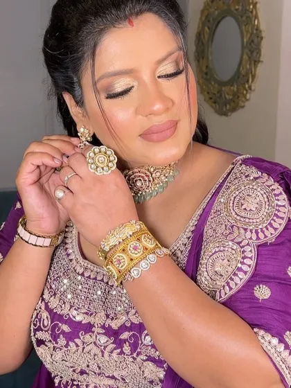 Adjusting her earrings, she looks absolutely radiant. This transformation reminds me why I love my job.