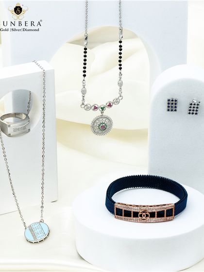 This image showcases a curated set of our silver jewellery, including a modern necklace, men's ring, and a stylish mesh bracelet, reflecting grace and beauty.