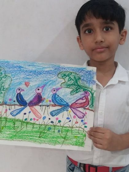 Ankur, a 2nd standard student, drew this sweet picture of a bird family. His oil pastel drawing shows two pairs of birds on a branch, creating a lovely story.