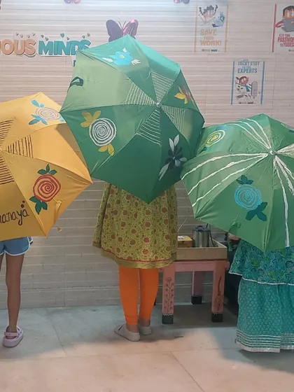 The kids love to hide behind their finished umbrellas. It's a fun way to show off their hard work and unique designs.