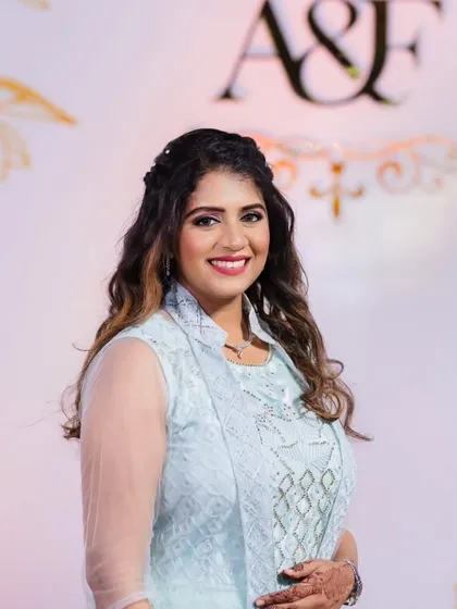 A soft and pretty look for a wedding guest. The makeup is minimal and fresh, with beautiful curls that frame her face.