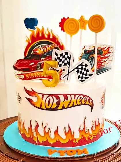 A Hot Wheels-themed cake with edible fire decals and car toppers. This design captures the speed and excitement of the popular toy cars.