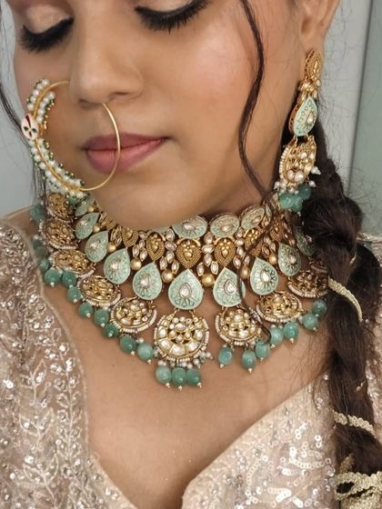 A close-up of the beautiful mint-green and kundan jewellery set available for rent.