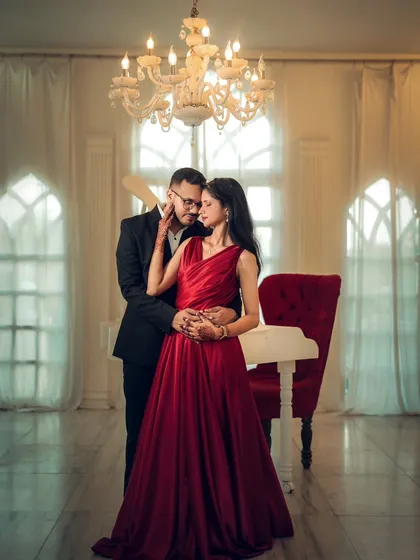 For a touch of fairytale romance, we can use elegant indoor sets. This shot of Nikhil and Anisha, surrounded by the warm glow of a chandelier, shows how a pre-wedding shoot can be both grand and deeply intimate.