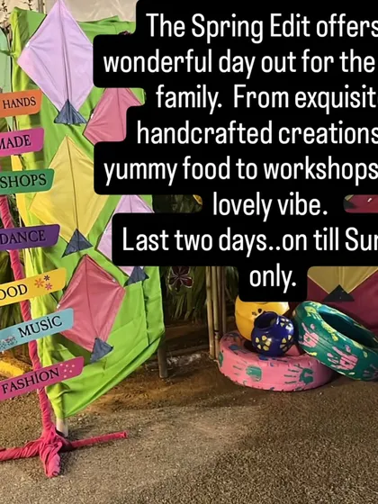 A colourful signpost guides visitors to the different experiences at our festival: handmade goods, workshops, dance, food, music, and fashion.