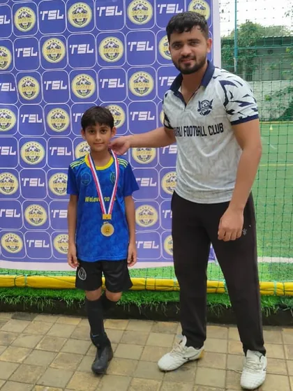 A proud coach with a deserving player. Our Head Coach, Siddhesh Tambekar, celebrating a U8 player's medal at a TSL event.