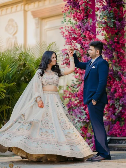 A classic romantic pose in front of a stunning floral wall. Ria and Deepanshu's engagement photos are full of elegance and charm.