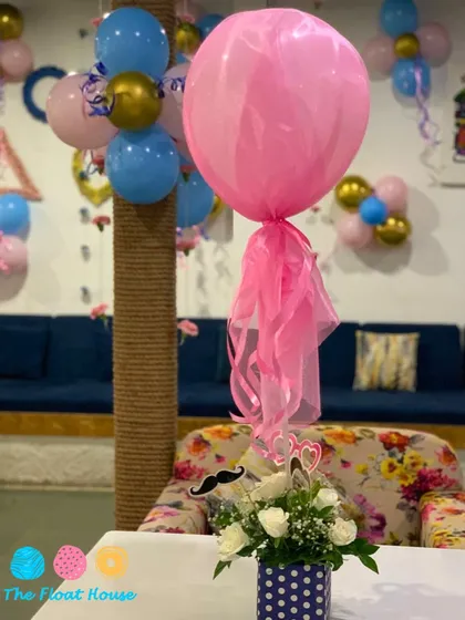 A close-up of the delicate decorations for a baby shower, including floral arrangements and themed balloons, showcasing our attention to detail.