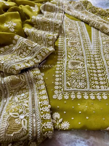 A detail shot of the sleeve and dupatta, showing the coordinated embroidery patterns.