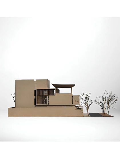 A physical model of the Akiri Residence, viewed from the side to show its layered composition and minimalist form.