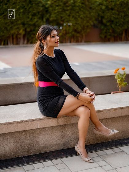 A seated pose that offers a more relaxed and casual feel, while still showcasing the stylish outfit and accessories.