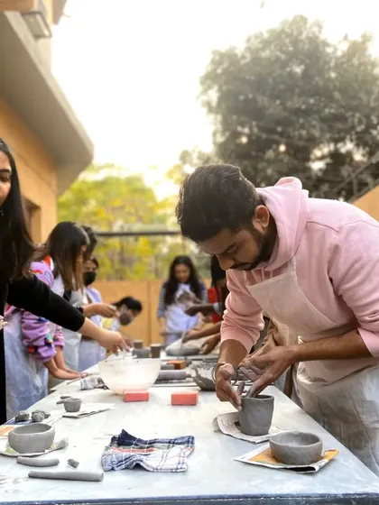 Our workshops bring people together for a day of creativity and fun, like this outdoor hand-building session.