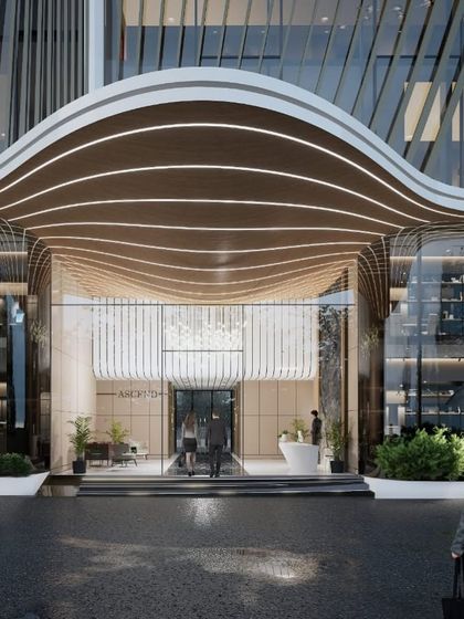 The main entrance of the Pune commercial tower, showcasing the interplay of light, form, and texture. The design creates a sophisticated and welcoming threshold for a modern commercial building.