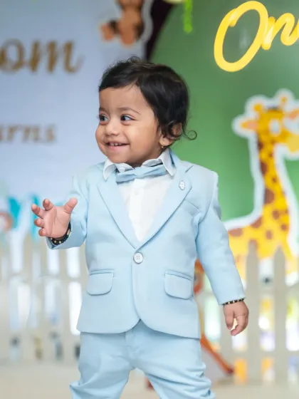 A charming close-up of the birthday boy in his light blue suit, looking dapper and ready to celebrate his first birthday.