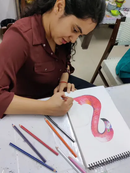 A series of images showing an adult student drawing a vibrant flamingo with color pencils, from the initial sketch to the final blended colors.