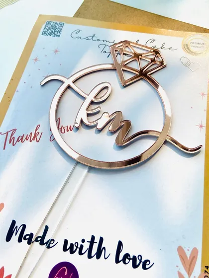 A unique two-letter "KM" topper inside a diamond ring design, made in a beautiful rose pink finish for a customer in Dubai.