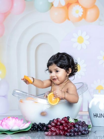 A playful moment in the milk bath, with a beautiful daisy backdrop.