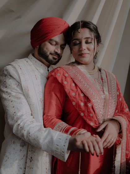 An intimate portrait of a Sikh couple sharing a quiet, loving embrace. The soft lighting and their serene expressions make this a powerful and emotional photograph.