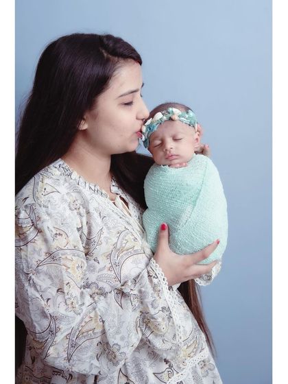 A mother's gentle kiss for her newborn. These are the quiet, tender moments that truly define the newborn experience.