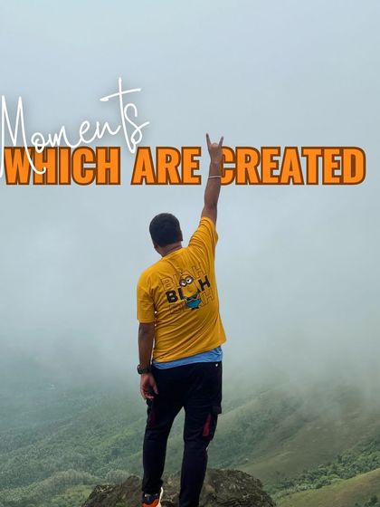 Moments which are created. A trekker celebrating on a misty peak, embodying the sense of freedom and achievement that our trips provide.