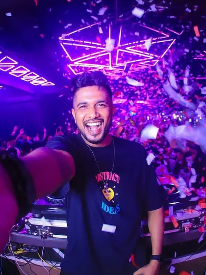 A wide-angle selfie from the DJ booth at Club Illusions, capturing my ecstatic expression and the confetti-filled air.