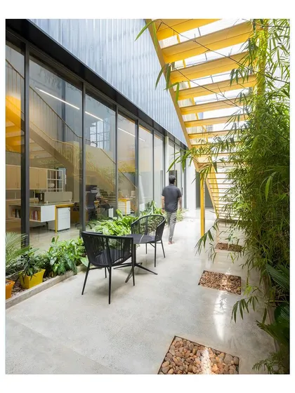 I designed this internal courtyard to bring nature into the workplace. It serves as a tranquil breakout space and provides a green view for the adjoining offices, promoting employee well-being.