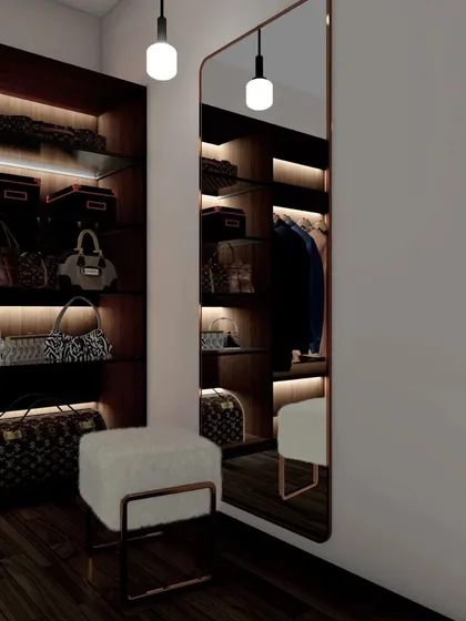 A walk-in closet featuring dark wood shelving with accent lighting, a full-length mirror, and a chic ottoman, creating a perfect dressing area.