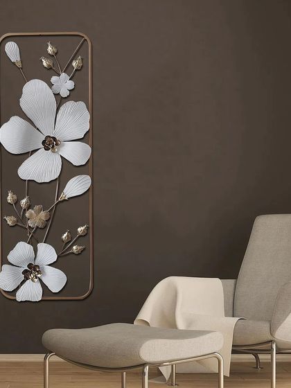 This vertical metal wall art features delicate white flowers on a golden branch. The clean lines and elegant design make it a perfect piece for a narrow wall or a quiet corner.